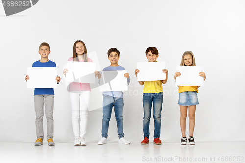 Image of Group of children with a white banners isolated in white