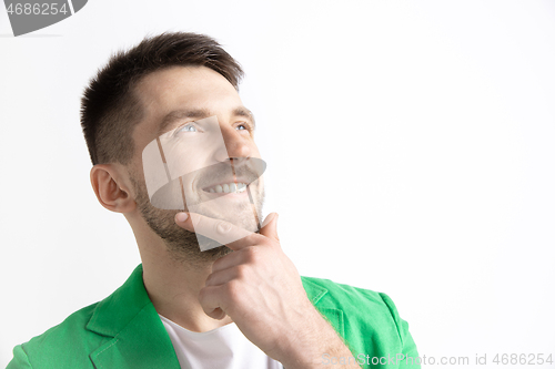 Image of Young dreaming man isolated on white background looking at something