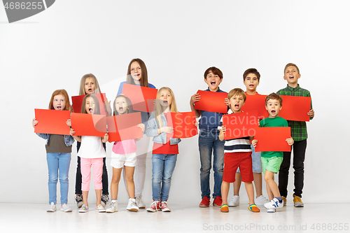 Image of Group of children with a red banners isolated in white