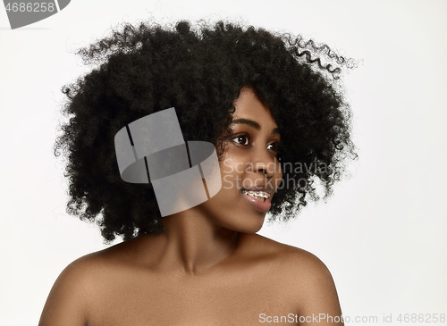 Image of Portrait of a young black woman smiling with braces