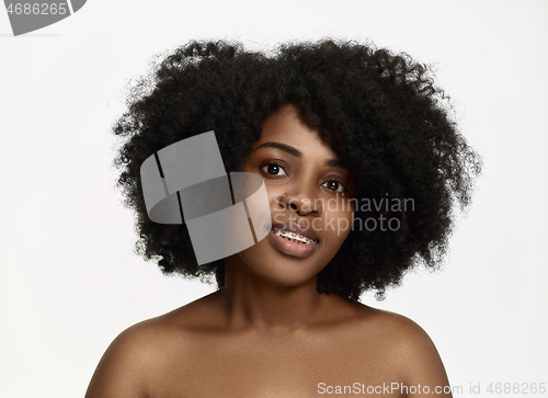 Image of Portrait of a young black woman smiling with braces