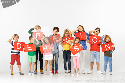 Image of Depression kills your character. Group of children with red banners isolated in white