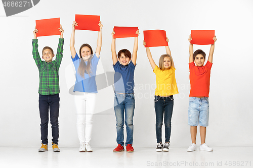 Image of Group of children with red banners isolated in white