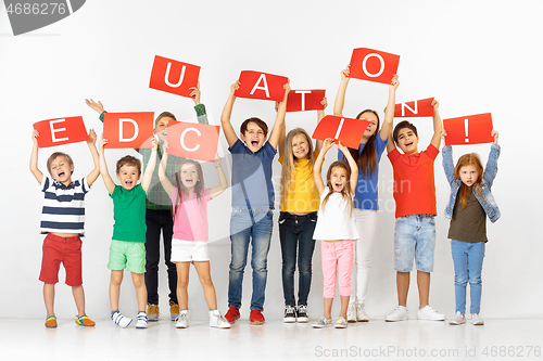 Image of Education. Group of children with a red banners isolated in white