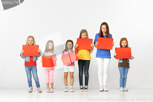 Image of Group of children with red banners isolated in white