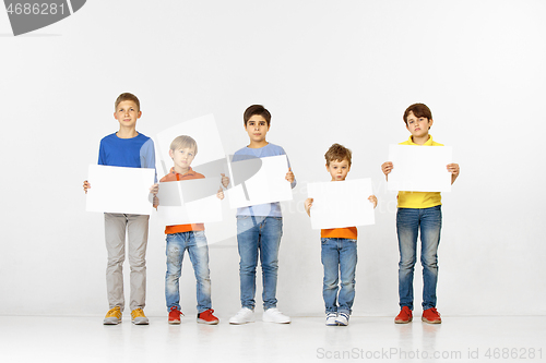 Image of Group of children with a white banners isolated in white