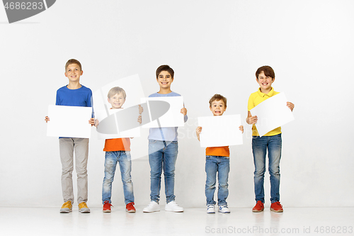 Image of Group of children with a white banners isolated in white