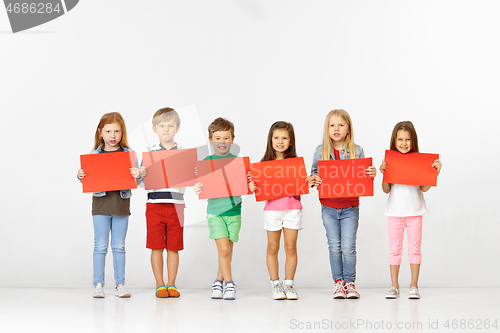 Image of Group of children with red banners isolated in white