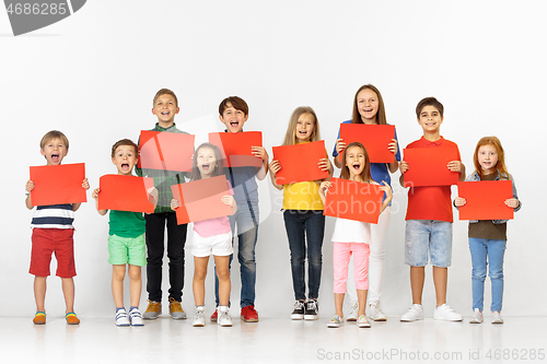 Image of Group of children with a red banners isolated in white