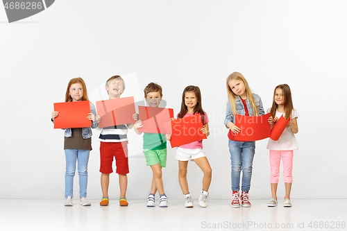 Image of Group of children with red banners isolated in white