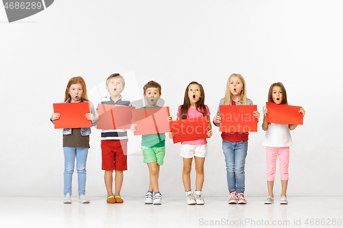 Image of Group of children with red banners isolated in white