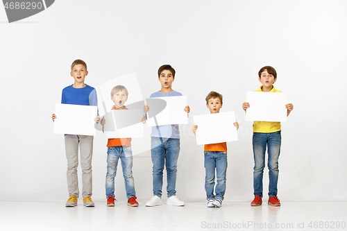 Image of Group of children with a white banners isolated in white