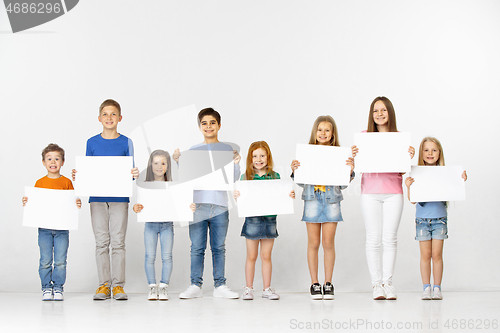 Image of Group of children with a white banners isolated in white