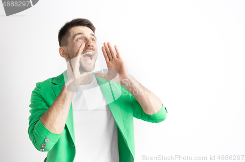 Image of Young casual man shouting. Shout.