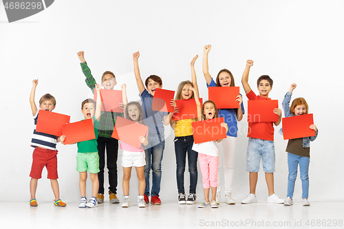 Image of Group of children with a red banners isolated in white