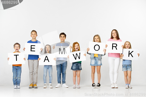 Image of Teamwork. Group of children with a banners isolated in white