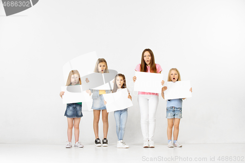 Image of Group of children with a white banners isolated in white