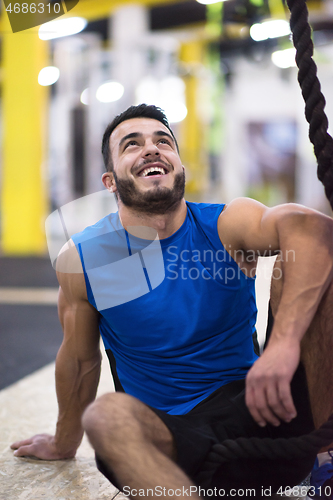 Image of man relaxing before rope climbing