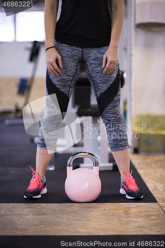 Image of woman exercise with fitness kettlebell