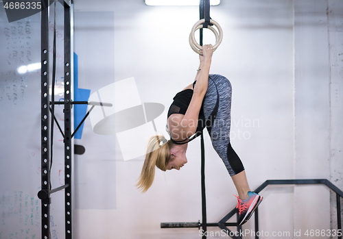 Image of woman working out on gymnastic rings