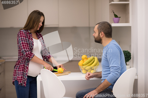 Image of couple cooking food fruit lemon juice at kitchen