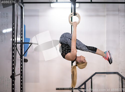 Image of woman working out on gymnastic rings