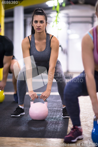 Image of athletes doing exercises with kettlebells