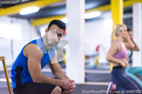 Image of young athletes doing pushups with kettlebells