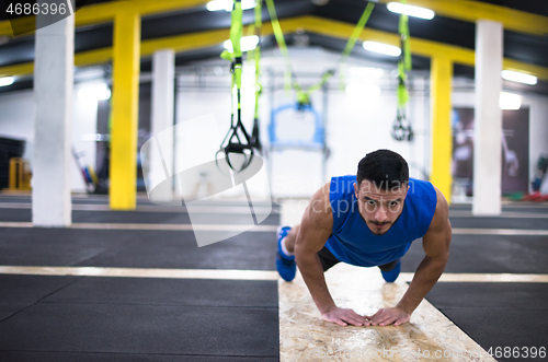 Image of Young  man doing pushups