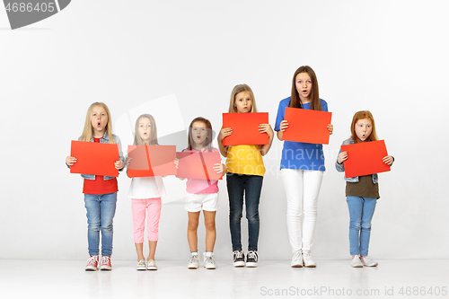 Image of Group of children with red banners isolated in white