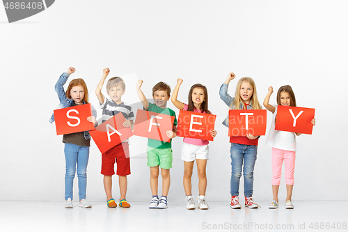 Image of Safety. Group of children with red banners isolated in white