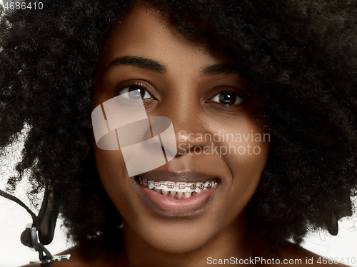 Image of Portrait of a young black woman smiling with braces