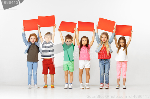 Image of Group of children with red banners isolated in white