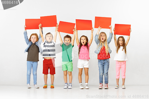 Image of Group of children with red banners isolated in white