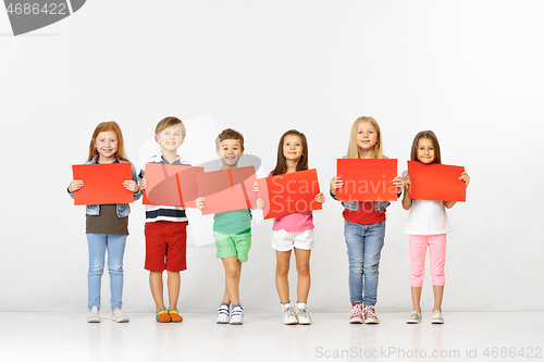 Image of Group of children with red banners isolated in white