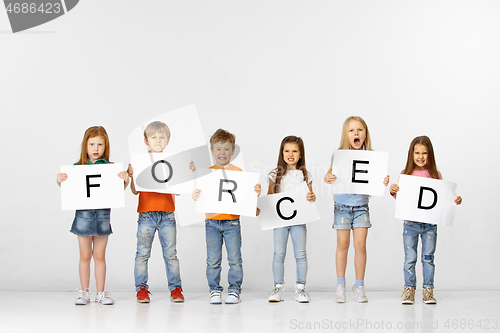 Image of Forced. Group of children with a banners isolated in white