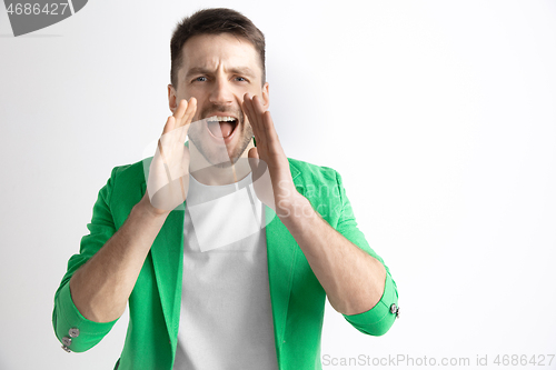 Image of Young casual man shouting. Shout.