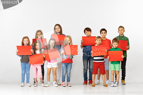 Image of Group of children with red banners isolated in white