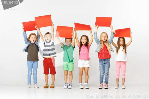 Image of Group of children with red banners isolated in white