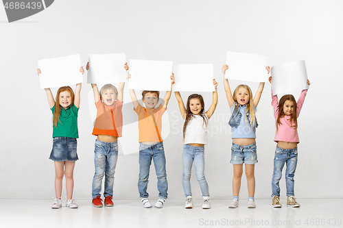 Image of Group of children with a white banners isolated in white