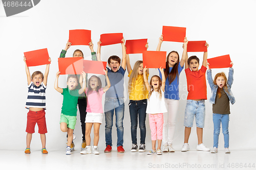 Image of Group of children with a red banners isolated in white