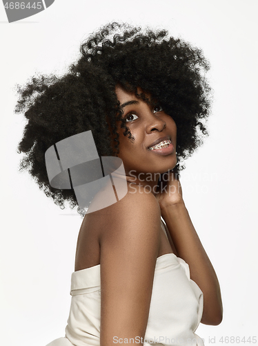 Image of Portrait of a young black woman smiling with braces