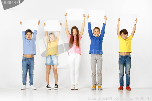 Image of Group of children with a white banners isolated in white