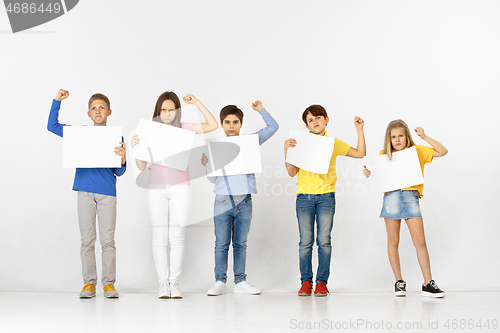 Image of Group of children with a white banners isolated in white