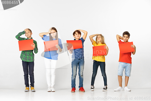 Image of Group of children with red banners isolated in white