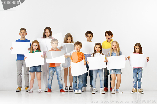 Image of Group of children with a white banners isolated in white