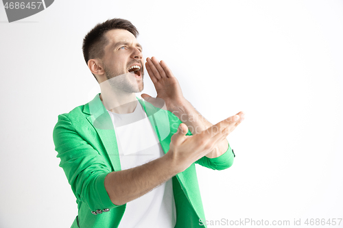 Image of Young casual man shouting. Shout.