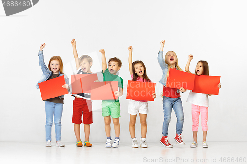 Image of Group of children with red banners isolated in white