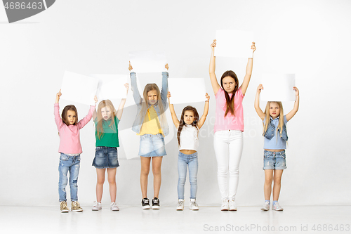 Image of Group of children with a white banners isolated in white