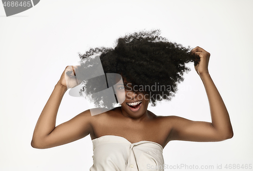 Image of Portrait of a young black woman smiling with braces